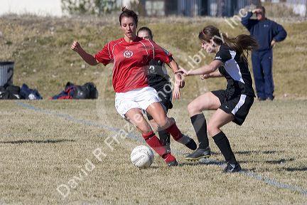Girls playing soccer.