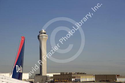 Air traffic control tower and Delta airplane at the Salt Lake City International Airport, Utah.
