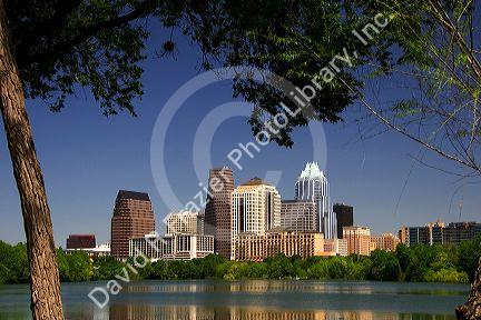 Cityscape skyline view of Austin, Texas with City Lake in the foreground.