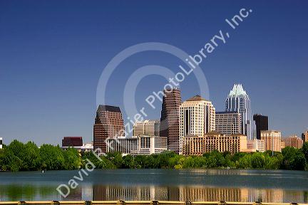 Cityscape skyline view of Austin, Texas with City Lake in the foreground.