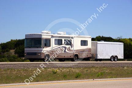 A recreational vehicle pulling a trailer on  Texas interstate highway 10.
