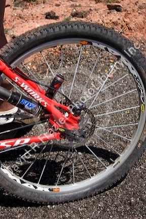 Mountain biking in the desert near Moab, Utah. Detail of disc brake and shock absorber.  (Model released)