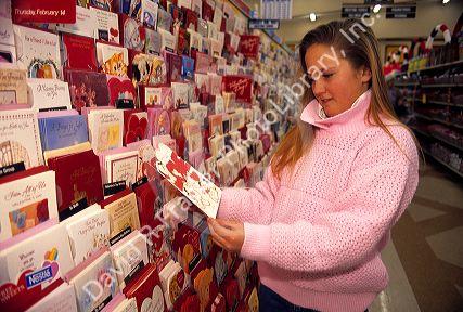 Young girl shopping for greeting cards.