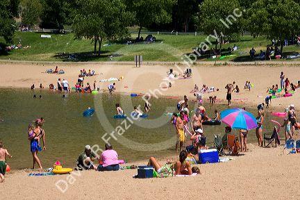 Adults and children play on the beach and in the water at Sandy Point near Boise, Idaho.