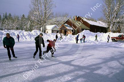 Children and adults ice skate in Idaho City, Idaho.