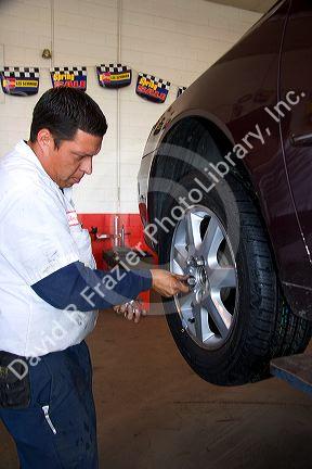 Installing tire on automobile.