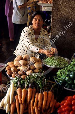 A street vendor selling vegetables in Saigon, Vietnam.