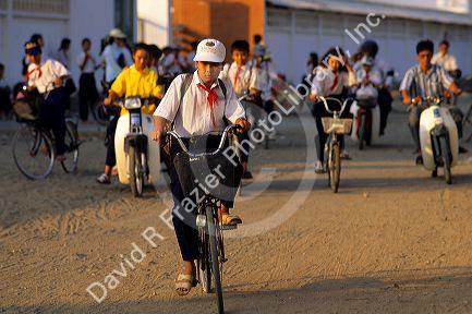 Students leave school on bicycle and scooters in Vung Tau, Vietnam.