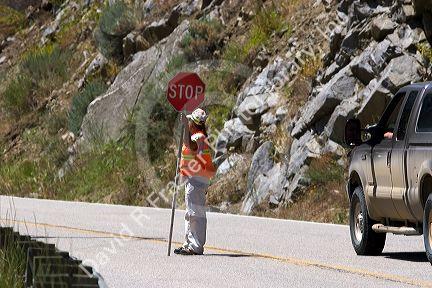 Female flagger stopping traffic for road construction in Idaho.