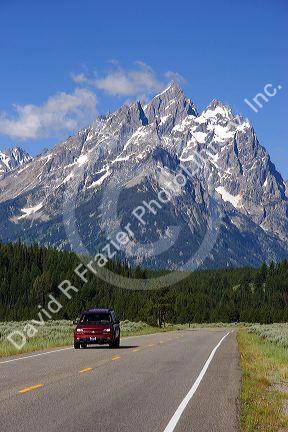 Vehicles travel on the highway through Grand Teton National Park, Wyoming.