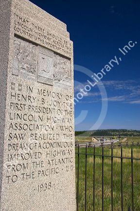 The Lincoln Highway Memorial along I-80 in Wyoming. Sign reads that it is the first cross country paved road in the United States of America.