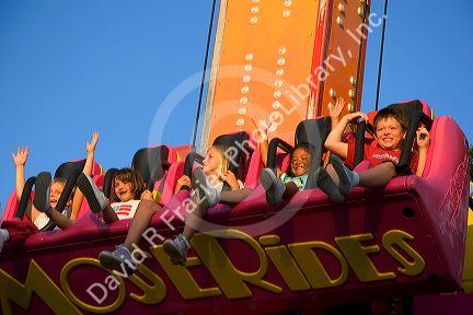 Children having fun on a ride at the Iowa state fair in Des Moines.