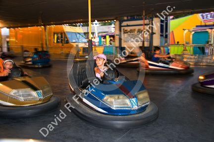 Children and adults ride bumper cars at the Iowa state fair in Des Moines.