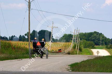 Amish boys travel by horse and carriage west of Bloomfield, Iowa.