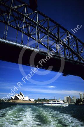 A view of the Sydney Opera House with tour boat and Harbor Bridge, Austrailia.