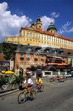 A couple bicycling at Melk near the  Abbey, Austria.