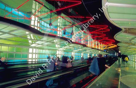 Moving sidewalk with neon lights overhead in the United terminal at Chicago's O'hare airport.