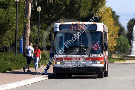 A passenger boards a bus on the campus at Stanford University in Palo Alto, California.