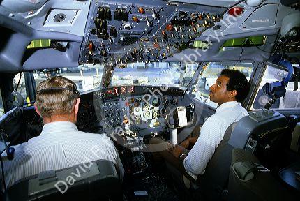 Pilot and co-pilot in the cockpit of a DC-10 commercial airplane.