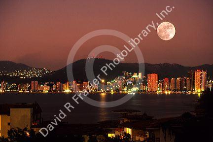 Full moon at night over Acapulco, Mexico.
