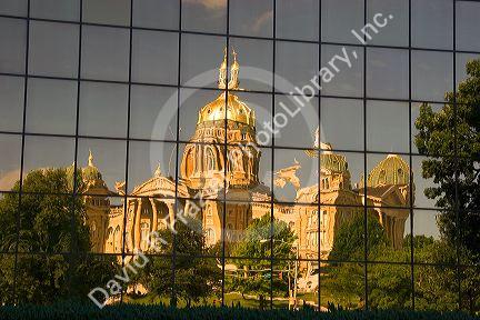A reflected and distorted view of the capitol building in Des Moines, Iowa in the windows of the Henry A. Wallace office building.