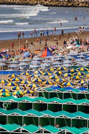 Colorful umbrellas and  cabanas in beach scene at Mar del Plata, Argentina.