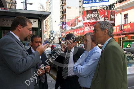 Business men talk on the street in Buenos Aires, Argentina.