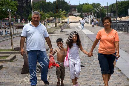 Argentine family walking and holding hands in the La Boca area of Buenos Aires, Argentina.