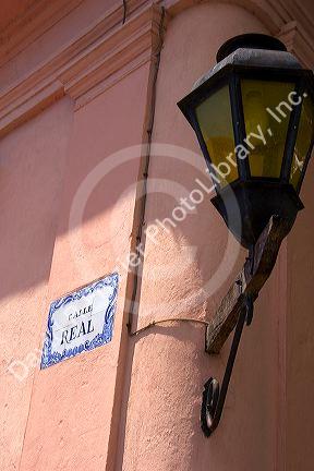 Tile street sign and lamp post in Colonia, Uraguay.