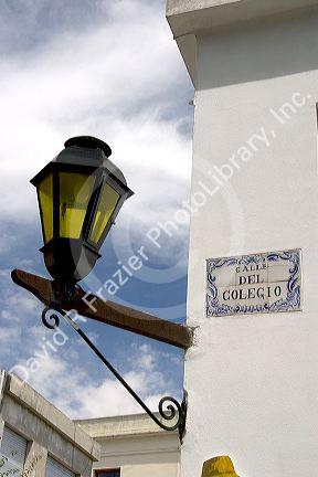 Tile street sign and lamp post in Colonia, Uraguay.