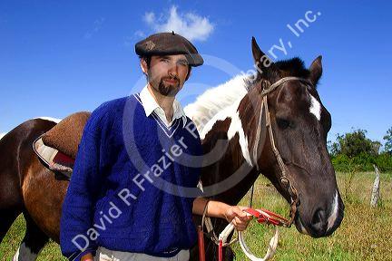 Gaucho riding a horse near Neccochea, Argentina.