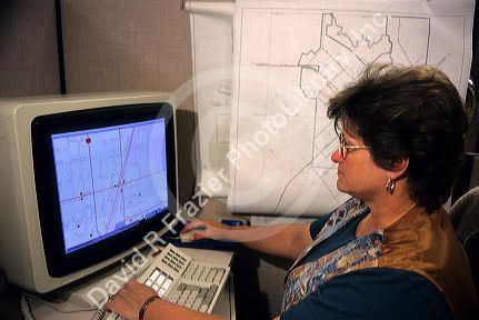 Cartographer, highway department map maker on a computer in Boise, Idaho.