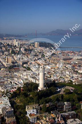 Aerial view of the city and bay of San Francisco, California with Coit Tower and Golden Gate Bridge in the background.