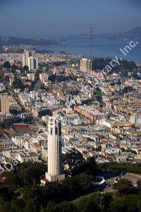 Aerial view of the city and bay of San Francisco, California with Coit Tower and Golden Gate Bridge in the background.
