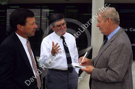 News media reporter interviews businessmen in Boise, Idaho.