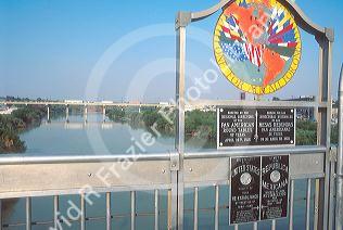The Rio Grande River at the  US/Mexico border with a sign in Laredo, Texas.