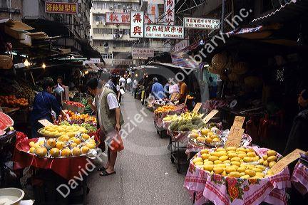 People shop at a traditional produce market in Hong Kong.