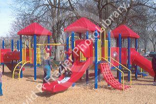 Children playing on plastic playground equiptment.
