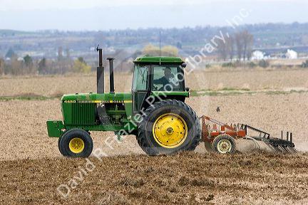Tractor spring tilling the soil in Twin Falls County, Idaho.