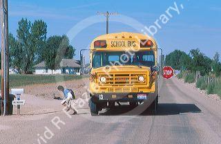 Child being dropped off at her bus stop by the school bus.