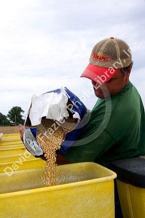 A farmer loading soy bean seeds into a planter in the east central delta region of Arkansas.