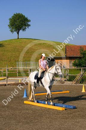 Rider on horseback at riding academy near Zurich, Switzerland.