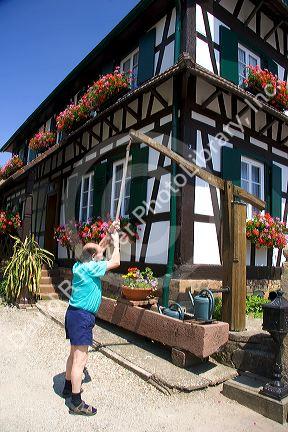 French man pumping water at the village of Betschdorf, France.