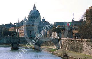 St. Peter's Basilica looms over the Tiber River in Rome, Italy.