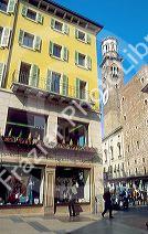 Pedestrian street scene in Verona, Italy.  Tower is the Torre del Lamberti.