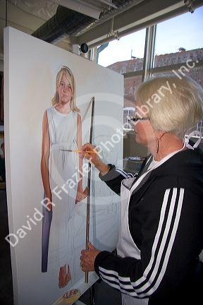 An artist painting on canvas at the Foundry Art Centre in St. Charles, Missouri. MR