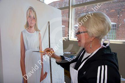 An artist painting on canvas at the Foundry Art Centre in St. Charles, Missouri. MR