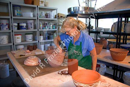 An artist making clay pots at the Foundry Art Centre in St. Charles, Missouri.