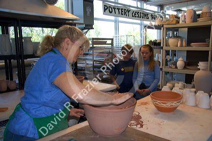 Children watch an artist making clay pots at the Foundry Art Centre in St. Charles, Missouri.