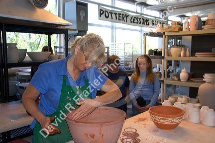 Children watching an artist making clay pots at the Foundry Art Centre in St. Charles, Missouri.